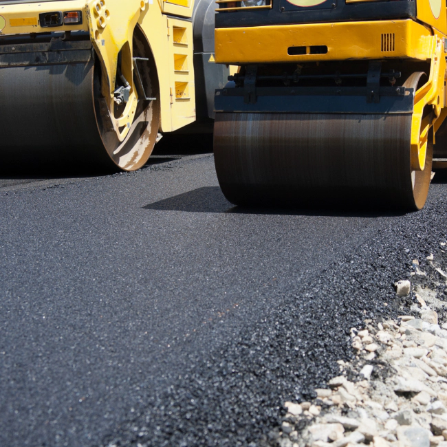 asphalt machines paving a street