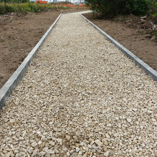 gravel base on a walkway being prepared to add some asphalt
